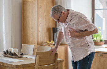 man holding his chest having a heart problem