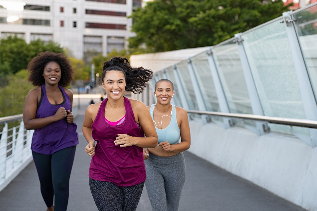 happy young curvy women jogging together