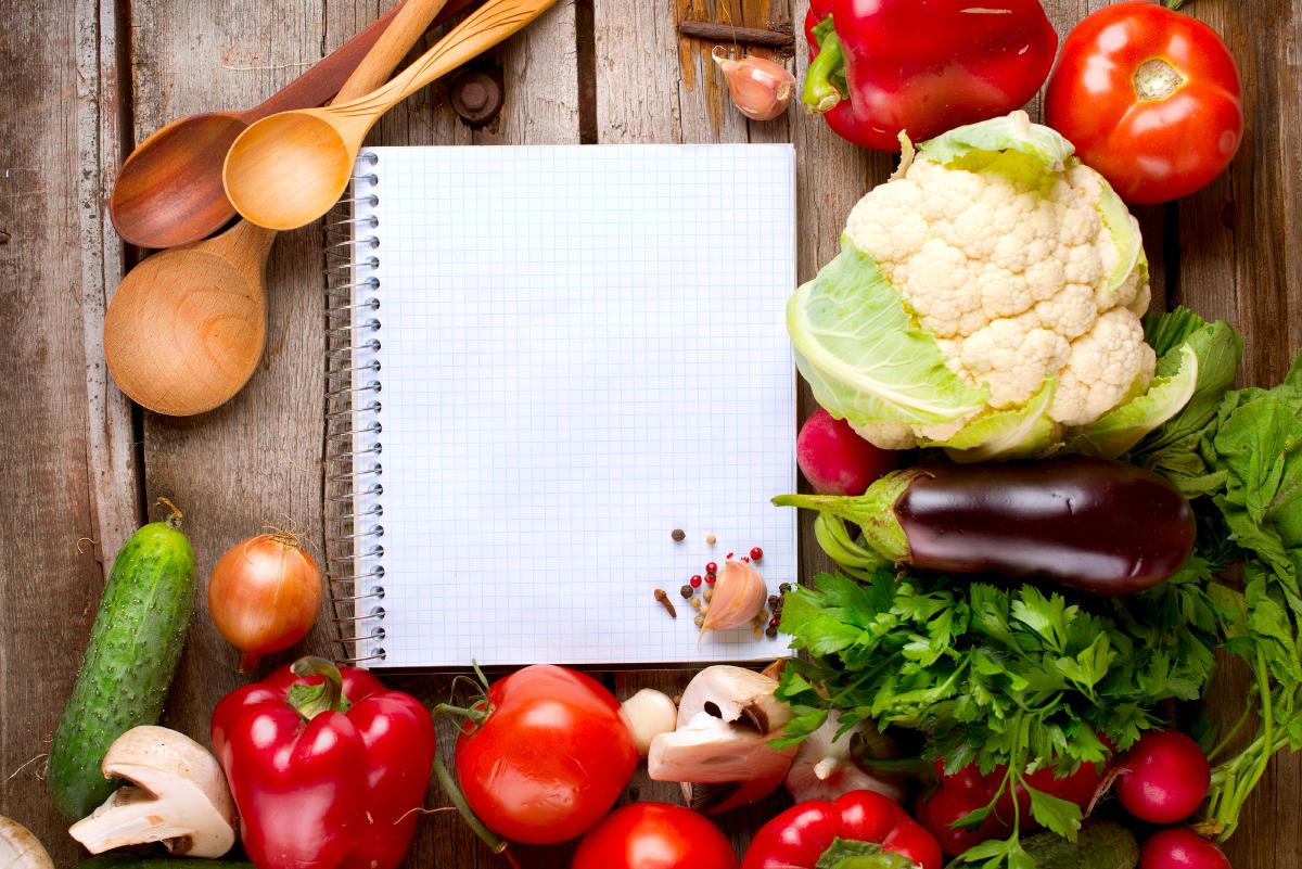 open notebook and fresh vegetables