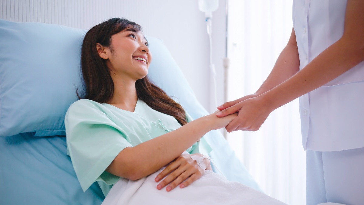 nurse is talking and giving encouragement to the patient after surgery