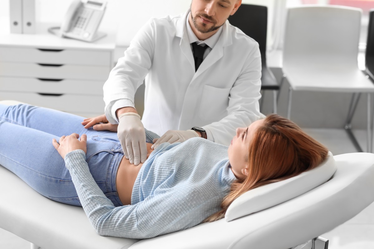 gastroenterologist examining woman in clinic