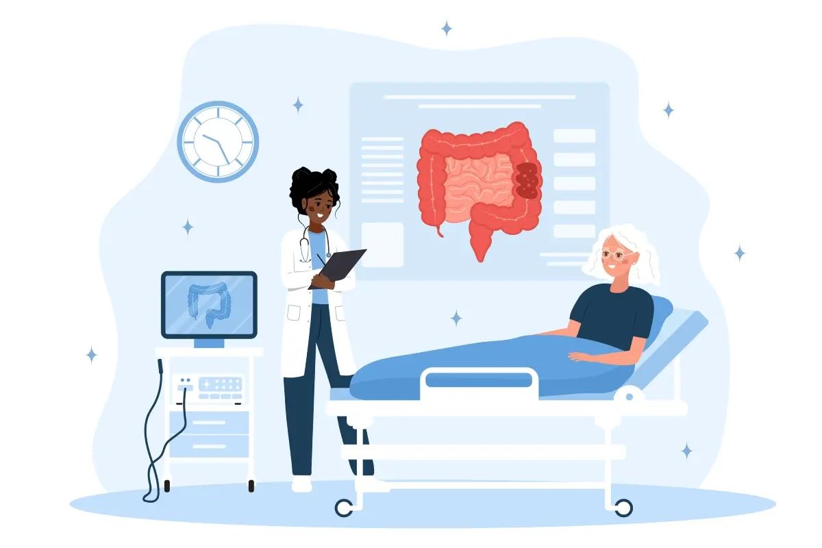 A doctor stands by a patient in a hospital bed with medical equipment and a large colon diagram displayed on the wall.