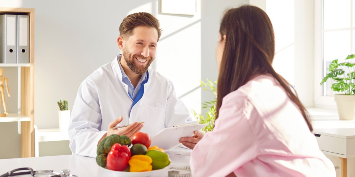 Medical weight loss consultation with doctor explaining nutrition and lifestyle changes.